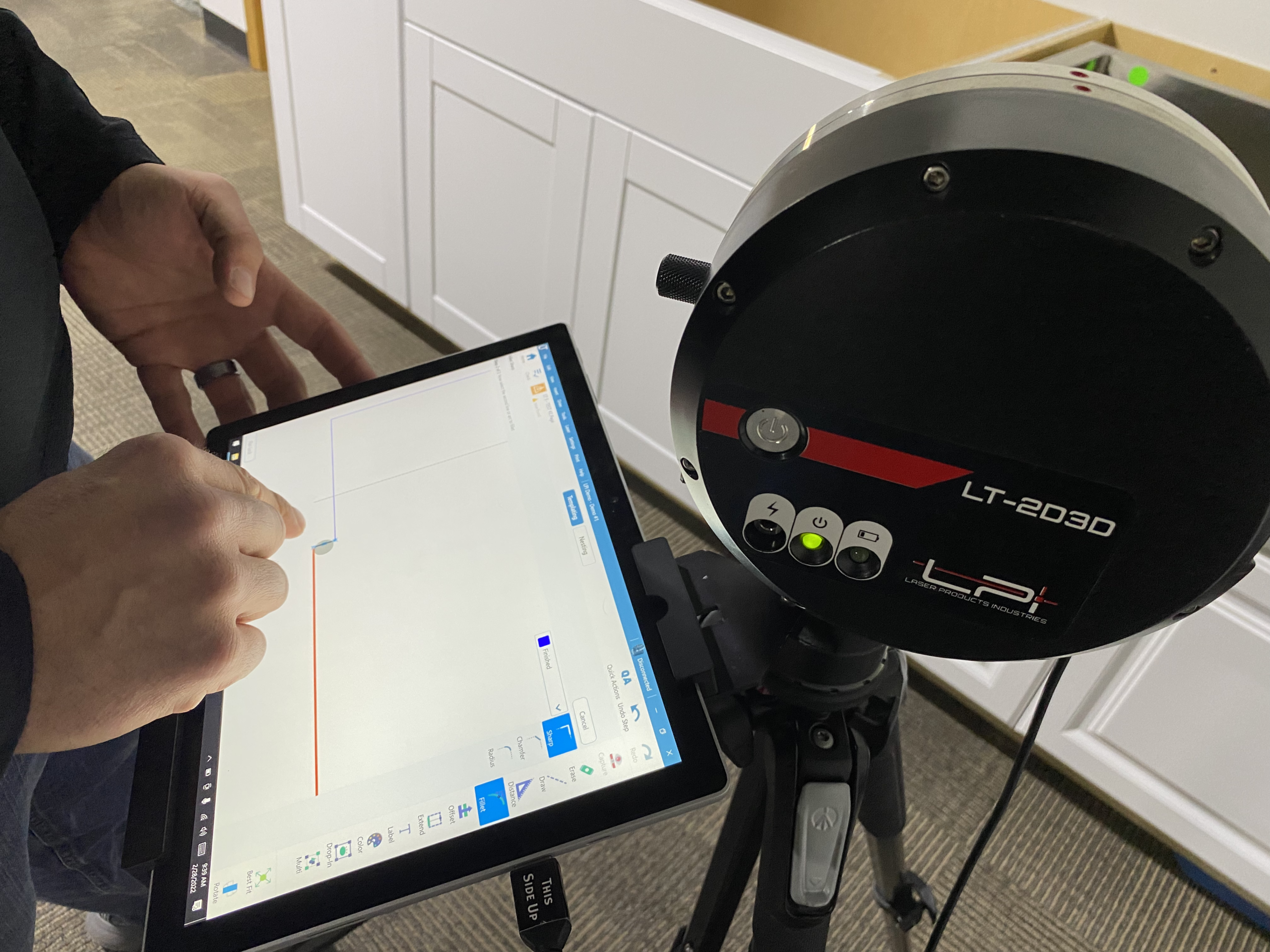 Claremont Kitchens stone worktop installation team using a Laser Products LT-2D3D laser templating system to take detailed measurements for a kitchen worksurface