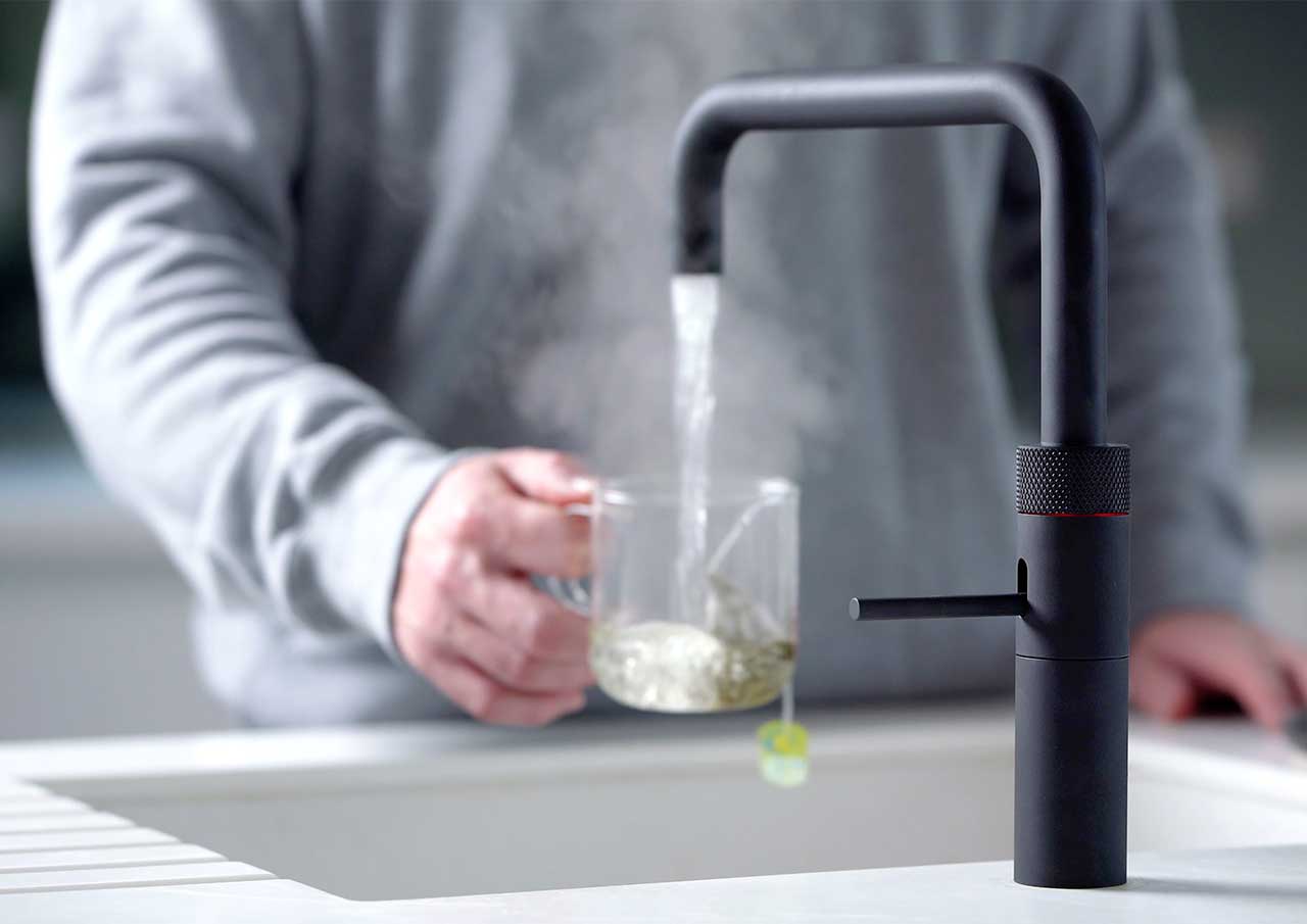 Black Fusion Quooker Taps dispensing instant boiling water for a hot drink