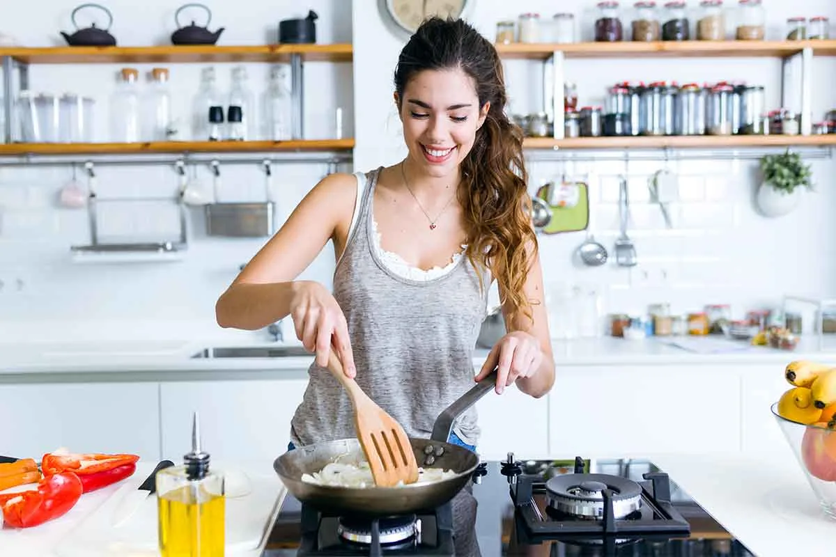 Woman cooking in an open plan kitchen