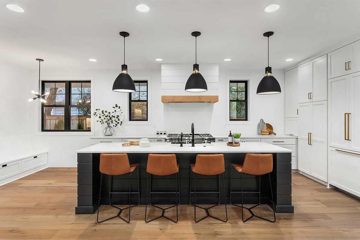 Large modern kitchen with black pendant lights and recessed ceiling lights
