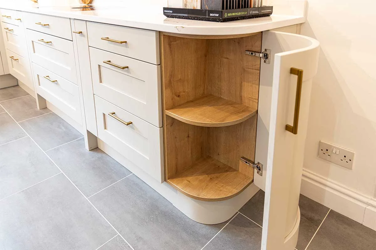 For new kitchen costs, budget around 30% of quality kitchen units like this curved Shaker corner cupboard at Claremont Kitchens and Interiors in Midhurst